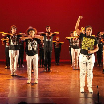 A scene from the 2017 Destiny Arts Youth Performance Company annual performance. Youth dancing on a stage.